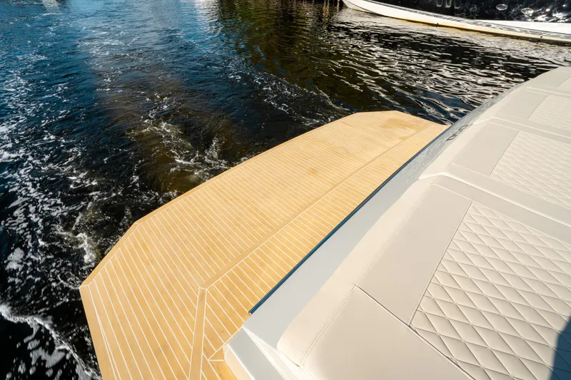 Slide: The Image of De Antonio Yachts D50 OPEN 2025, elegant deck design on water. - 10