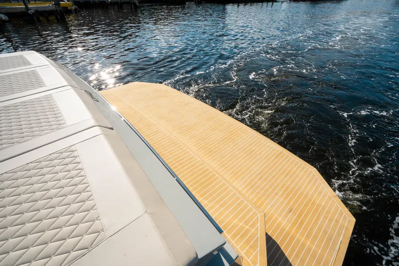 Slide: The Image of De Antonio Yachts D50 OPEN 2025, elegant deck view on sparkling water. - 11
