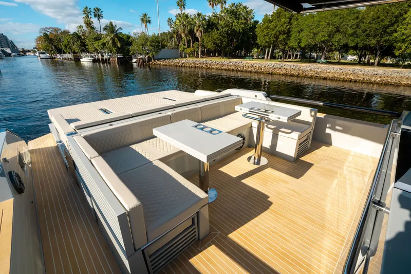 Slide: The Image of Luxurious 2025 De Antonio Yachts D50 OPEN with spacious deck seating and scenic waterfront view. - 16
