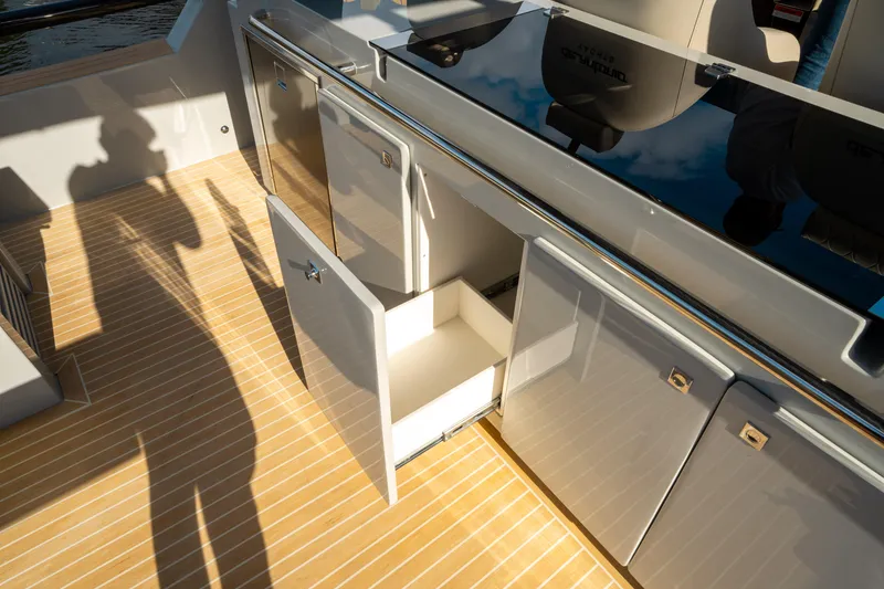 Slide: The Image of De Antonio Yachts D50 OPEN 2025 interior with open storage cabinets on deck. - 25