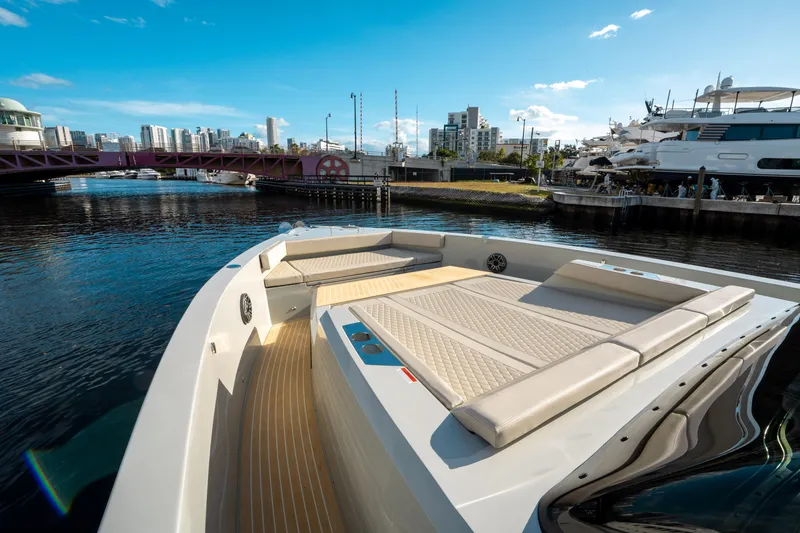 Slide: The Image of 2025 De Antonio Yachts D50 OPEN luxury yacht docked in a marina, featuring spacious deck seating. - 28