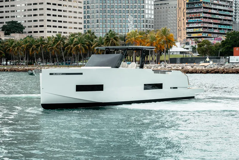 Slide: The Image of 2025 De Antonio Yachts D50 OPEN cruising near urban waterfront. - 3