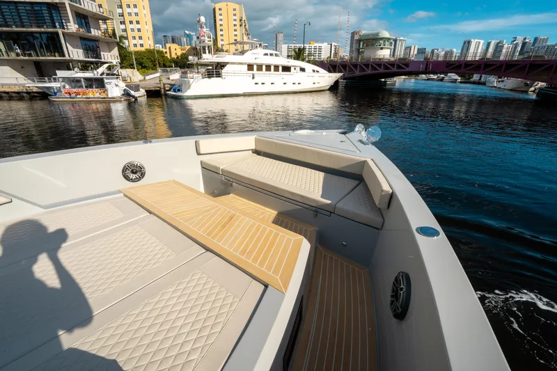 Slide: The Image of De Antonio Yachts D50 OPEN 2025 on a sunny waterfront with cityscape background. - 30