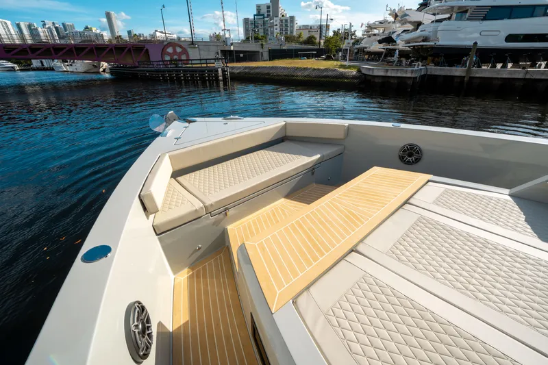 Slide: The Image of De Antonio Yachts D50 OPEN 2025, luxury deck view with seating, docked in urban marina. - 31
