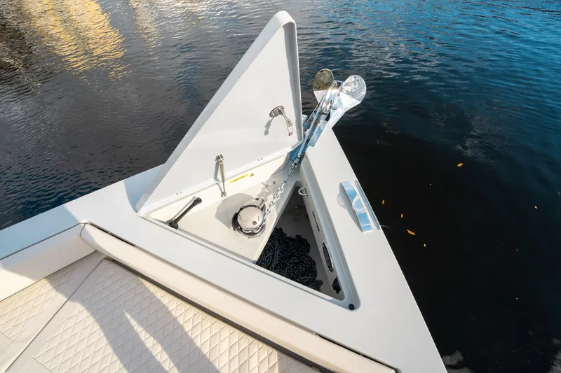 Slide: The Image of De Antonio Yachts D50 OPEN 2025 anchor compartment detail on calm water. - 33