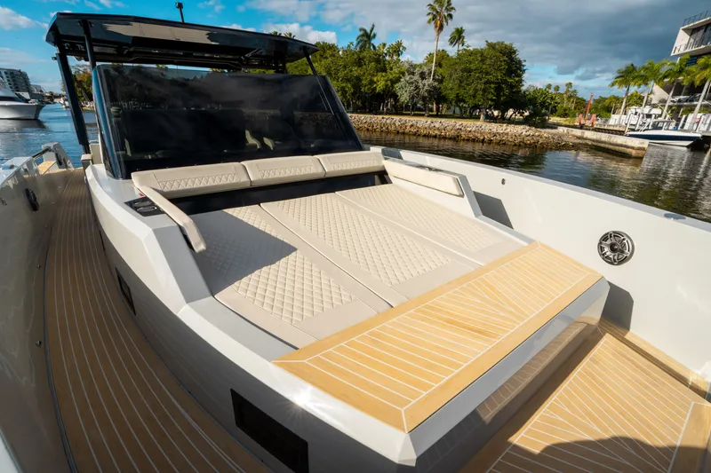 Slide: The Image of 2025 De Antonio Yachts D50 OPEN luxury yacht with sun deck, docked by lush greenery. - 35