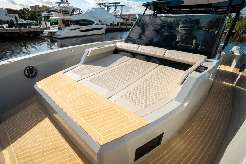 Slide: The Image of 2025 De Antonio Yachts D50 OPEN luxury deck with cushioned seating, docked at marina. - 36