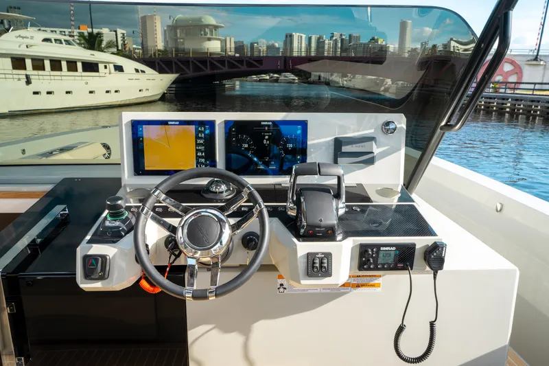 Slide: The Image of 2025 De Antonio Yachts D50 OPEN helm with modern navigation controls and cityscape view. - 40