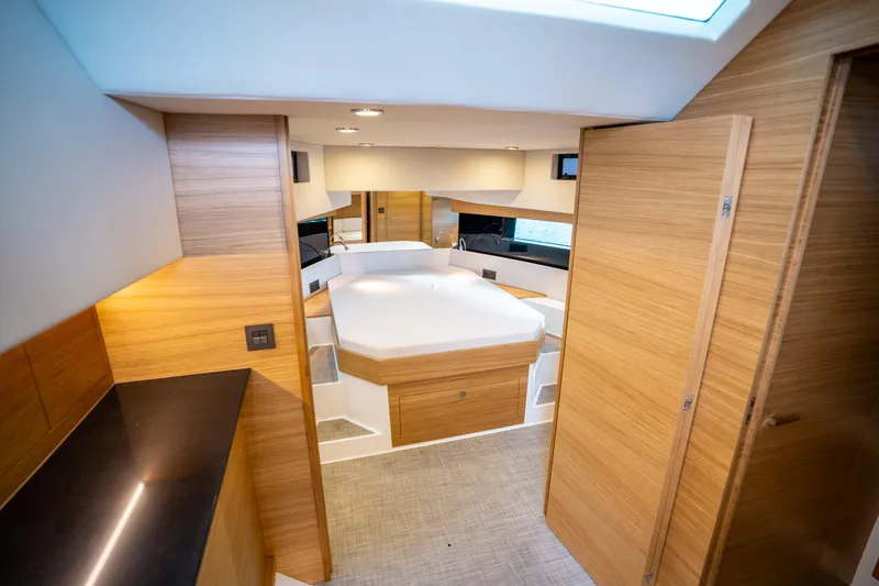 Slide: The Image of Interior of 2025 De Antonio Yachts D50 OPEN, featuring modern wood finishes and cozy sleeping area. - 42