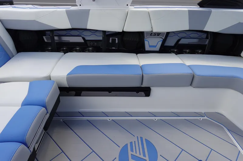 Slide: The Image of 2025 Malibu 23 LSV WAKESETTER interior with blue and white seating. - 12