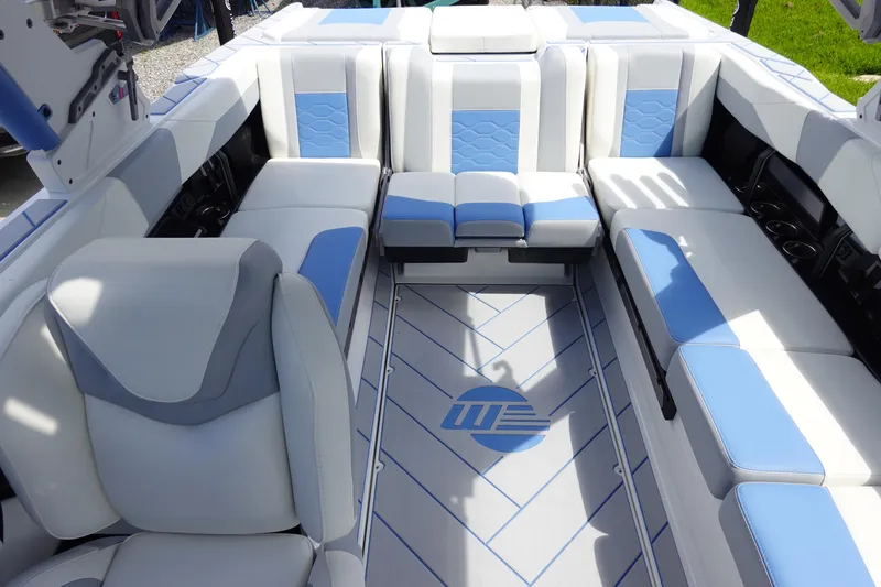Slide: The Image of Luxurious interior of 2025 Malibu 23 LSV WAKESETTER boat with blue and white seating. - 14