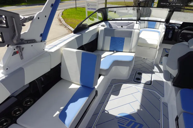 Slide: The Image of 2025 Malibu 23 LSV WAKESETTER interior with blue and white seating, sleek design. - 16