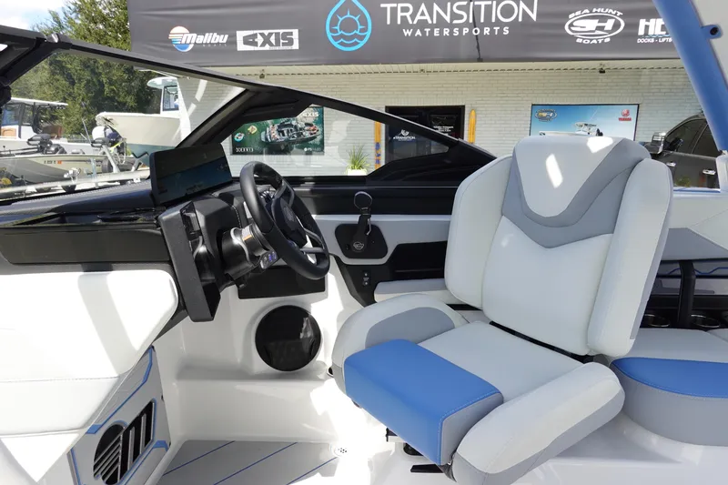 Slide: The Image of 2025 Malibu 23 LSV WAKESETTER interior with modern steering and seating at Transition Watersports. - 18