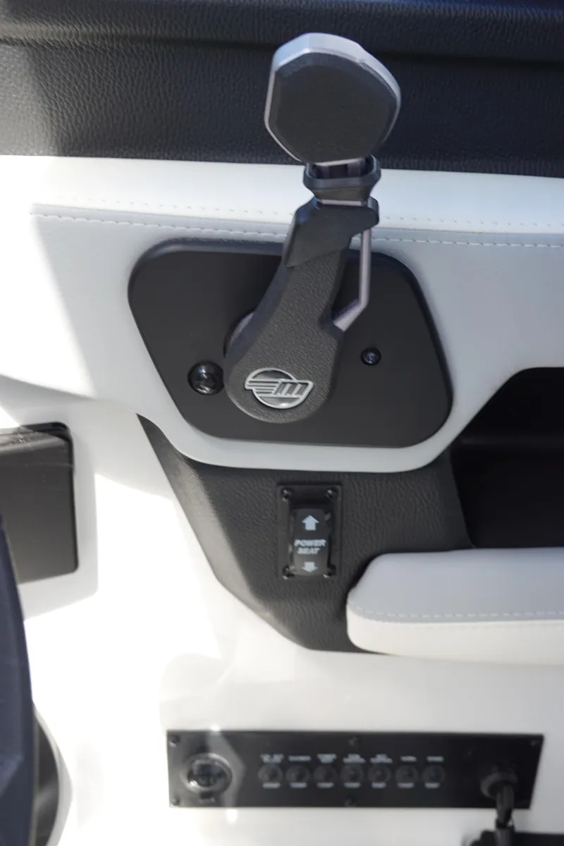 Slide: The Image of 2025 Malibu 23 LSV WAKESETTER boat control panel with throttle lever. - 20