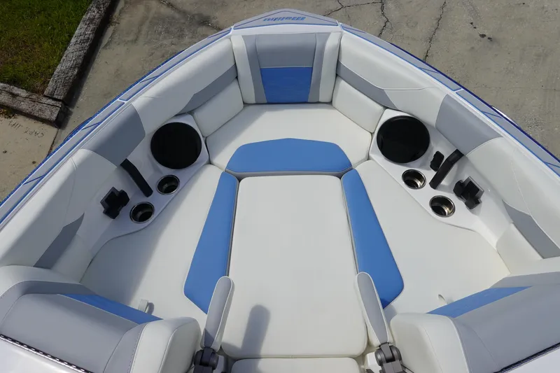 Slide: The Image of 2025 Malibu 23 LSV WAKESETTER boat interior with blue and white seating. - 21