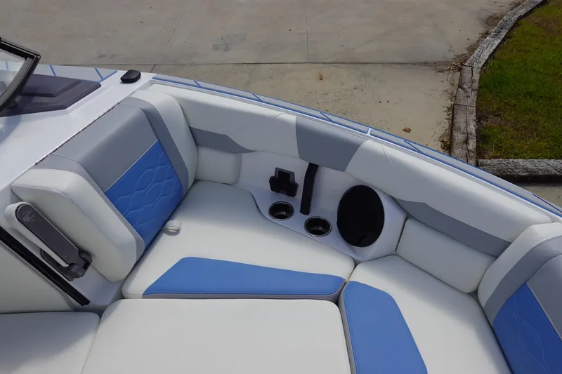 Slide: The Image of 2025 Malibu 23 LSV WAKESETTER boat interior with blue and white seating. - 22