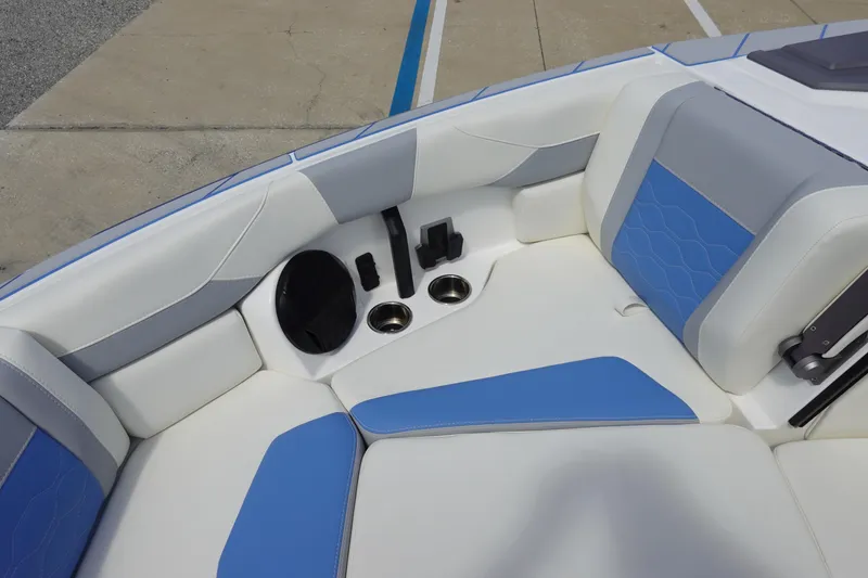 Slide: The Image of 2025 Malibu 23 LSV WAKESETTER boat interior with blue and white seating. - 23