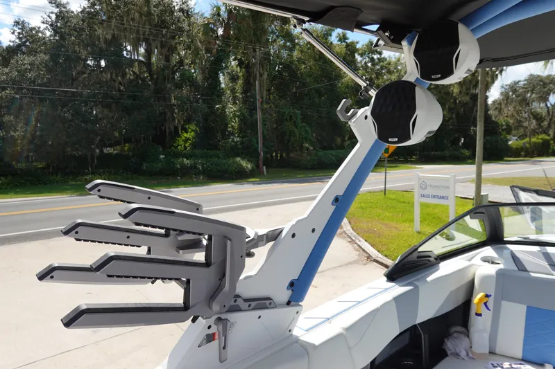 Slide: The Image of 2025 Malibu 23 LSV WAKESETTER boat interior with wakeboard rack and speaker. - 25