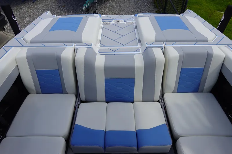 Slide: The Image of 2025 Malibu 23 LSV WAKESETTER boat interior with blue and gray seating. - 27