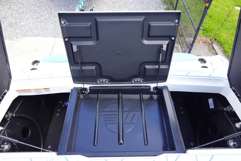 Slide: The Image of 2025 Malibu 23 LSV WAKESETTER storage compartment open, showcasing interior design. - 28