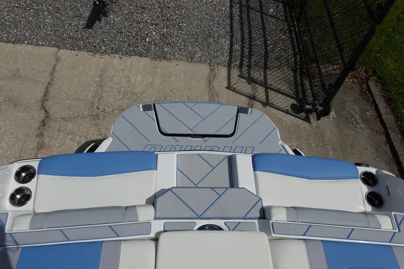 Slide: The Image of 2025 Malibu 23 LSV WAKESETTER boat interior with blue and white seating. - 30