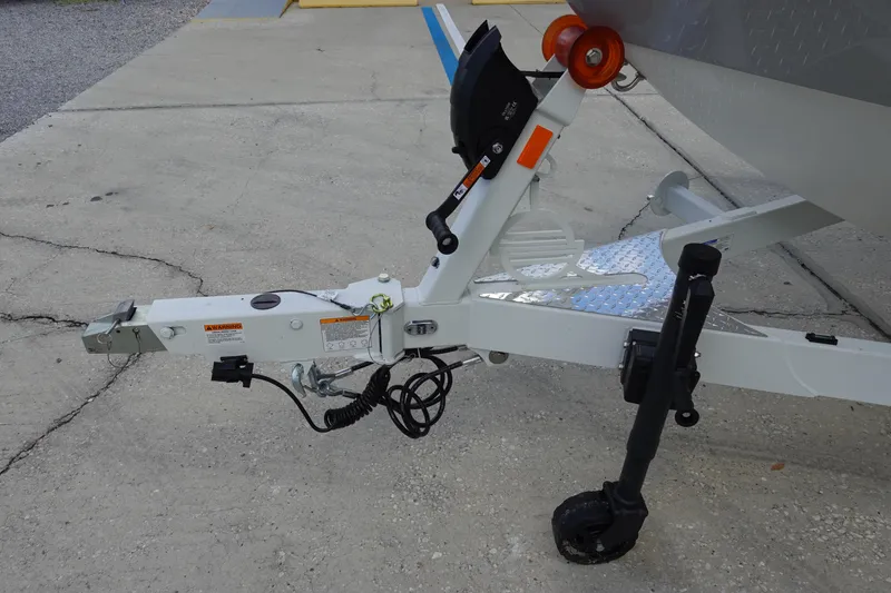 Slide: The Image of Trailer hitch of 2025 Malibu 23 LSV WAKESETTER boat on concrete surface. - 37