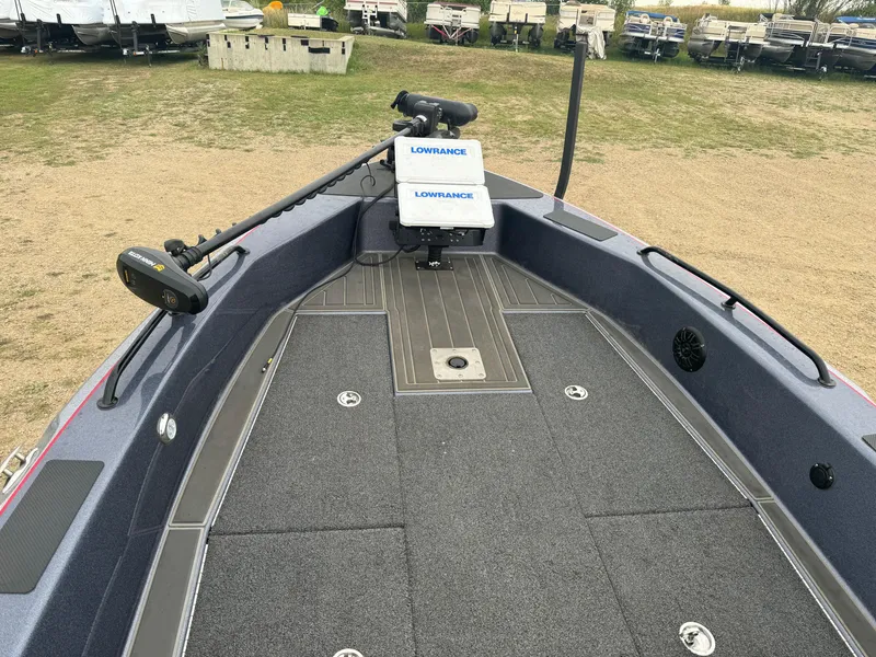 Slide: The Image of 2023 Warrior V2090 boat deck with Lowrance equipment, parked on grass. - 7