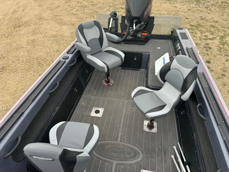 Slide: The Image of 2023 Warrior V2090 boat interior with gray seating and motor. - 9