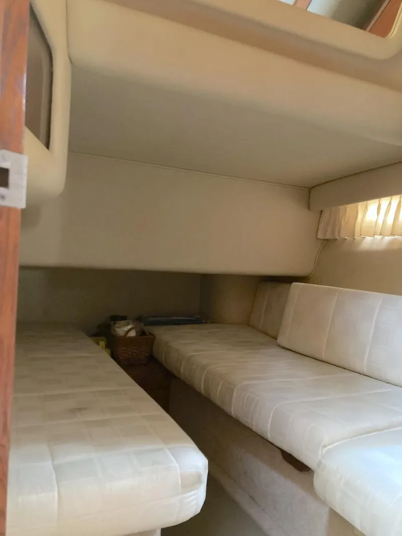 Slide: The Image of Interior cabin of 2000 Sea Ray 400 Sedan Bridge with beige seating. - 11