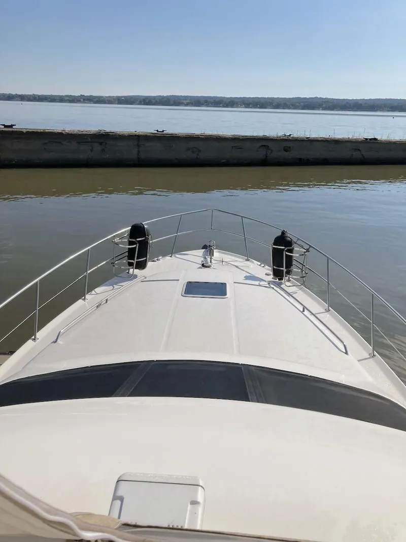 Slide: The Image of Bow view of 2000 Sea Ray 400 Sedan Bridge yacht on calm water. - 12