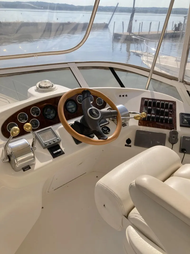 Slide: The Image of Interior helm of 2000 Sea Ray 400 Sedan Bridge yacht with steering wheel and controls. - 3