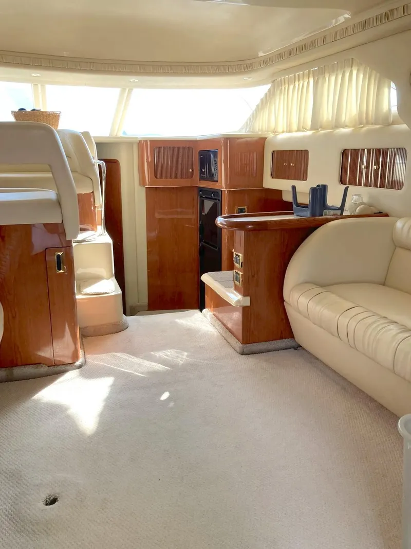 Slide: The Image of Interior of 2000 Sea Ray 400 Sedan Bridge yacht with plush seating and wood accents. - 5