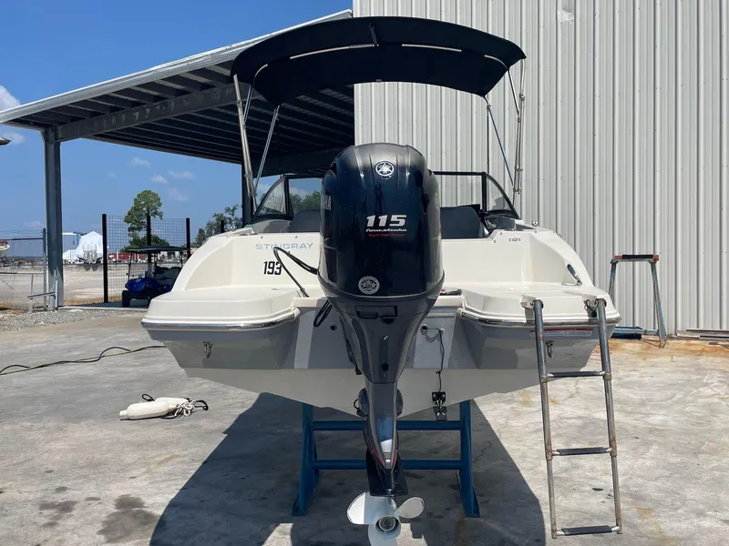 Slide: The Image of 2021 Stingray 191 DC boat with 115 HP engine, parked outdoors. - 10