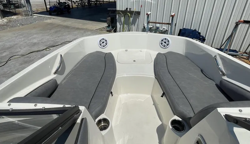 Slide: The Image of 2021 Stingray 191 DC boat interior with gray seating and speakers. - 3