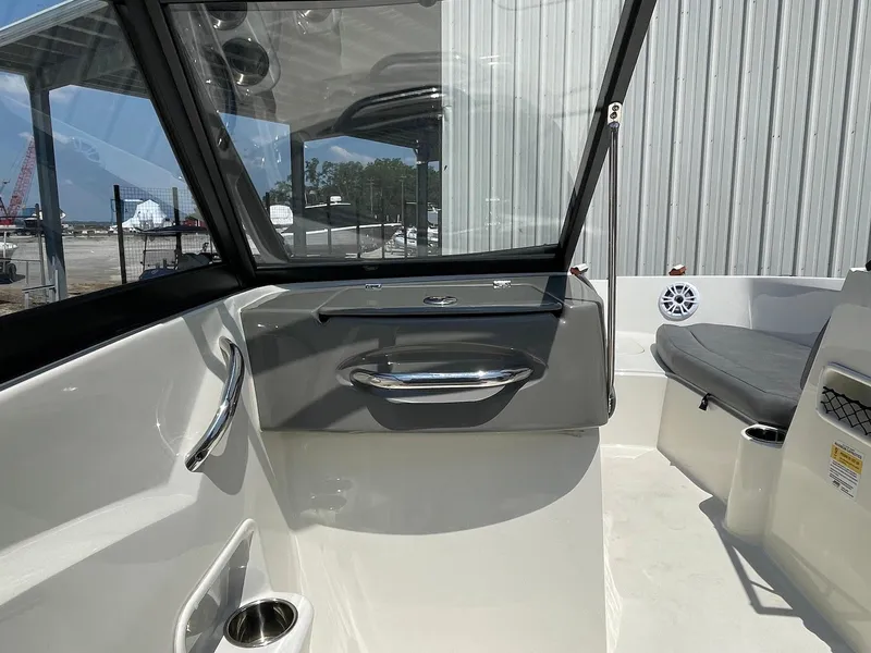 Slide: The Image of 2021 Stingray 191 DC boat interior with seating and modern dashboard design. - 6