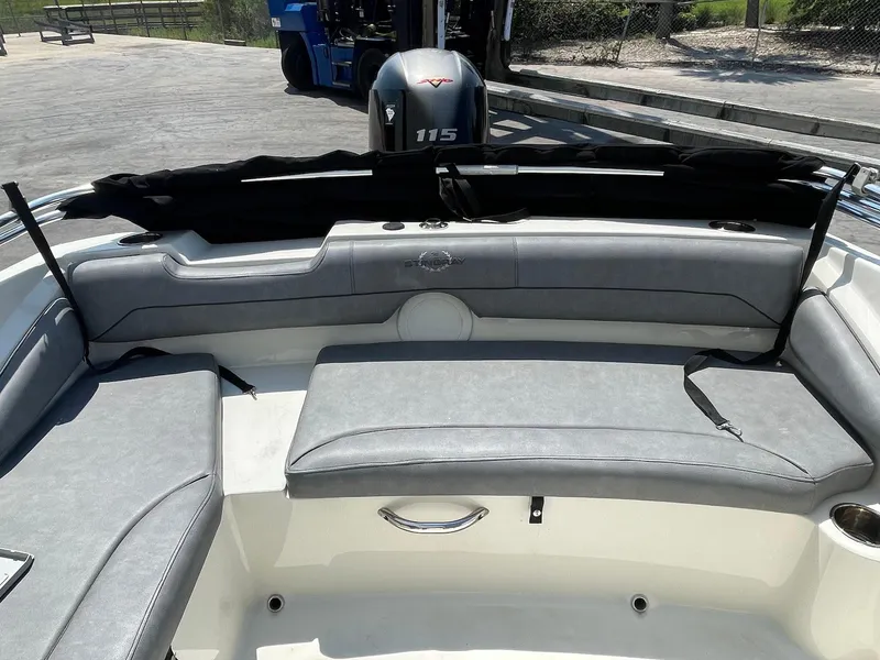 Slide: The Image of 2021 Stingray 191 DC boat interior with gray seating and 115 HP engine. - 7