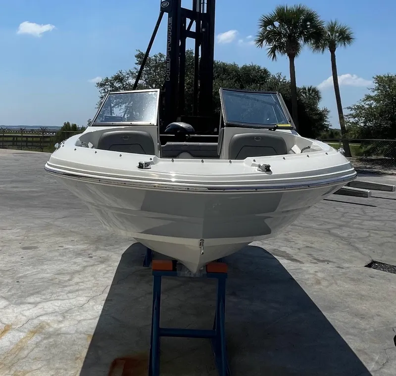 Slide: The Image of 2021 Stingray 191 DC boat on stand, outdoor setting with palm trees. - 9