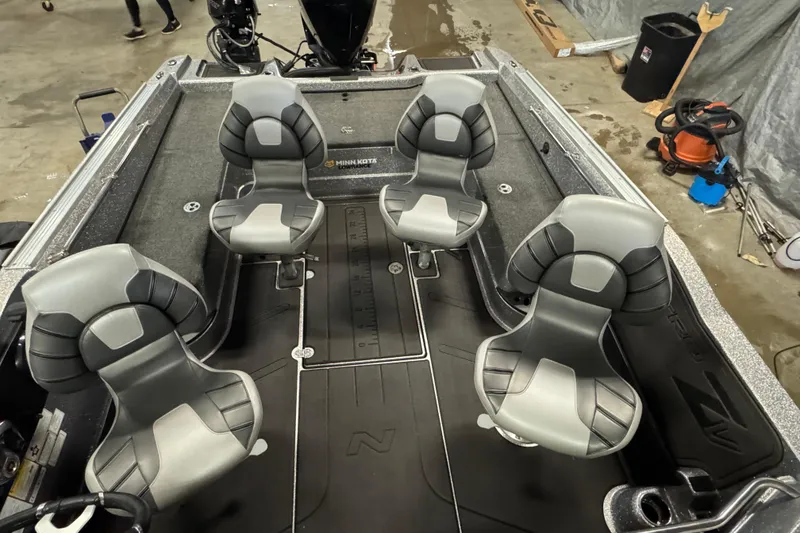 Slide: The Image of 2024 Nitro ZV20 boat interior with four gray seats and Minn Kota motor. - 16