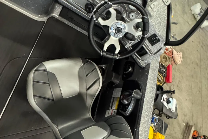 Slide: The Image of 2024 Nitro ZV20 boat interior with steering wheel and seat, showcasing modern design. - 5