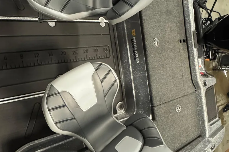 Slide: The Image of 2024 Nitro ZV20 boat interior with gray seats and measuring ruler. - 8