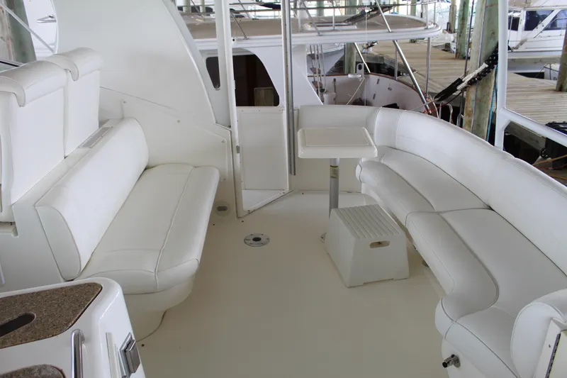 Slide: The Image of 2005 Cruisers 455 Express Motor Yacht interior with white seating and table. - 10