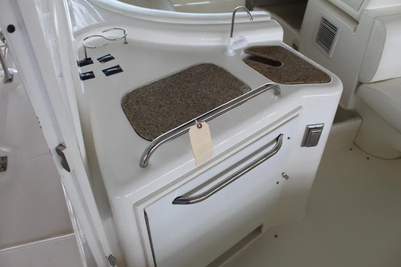 Slide: The Image of 2005 Cruisers 455 Express Motor Yacht interior kitchenette with countertop and storage. - 11
