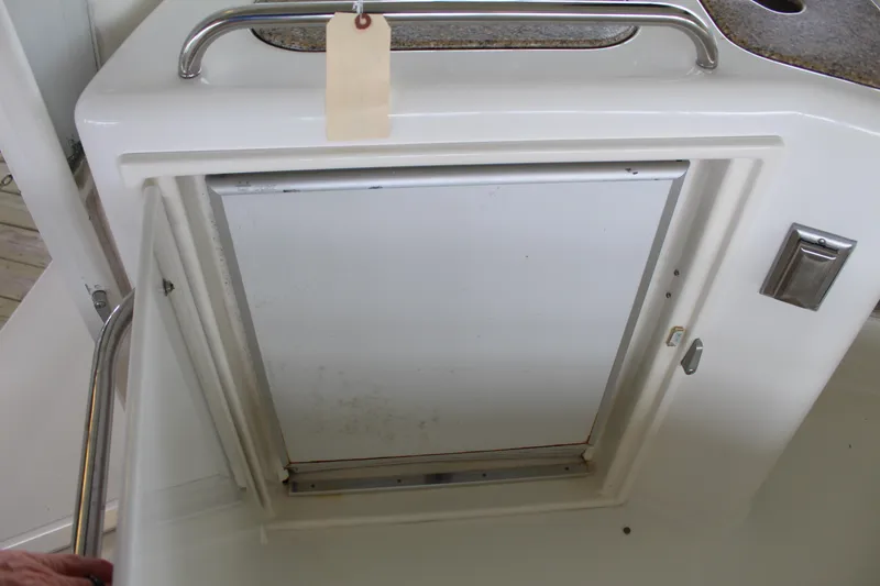 Slide: The Image of 2005 Cruisers 455 Express Motor Yacht interior compartment with handle and latch. - 12