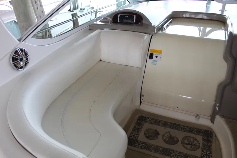 Slide: The Image of 2005 Cruisers 455 Express Motor Yacht interior with white seating and decorative mat. - 13