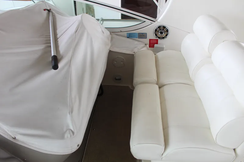 Slide: The Image of Interior of 2005 Cruisers 455 Express Motor Yacht with white seating and covered controls. - 14