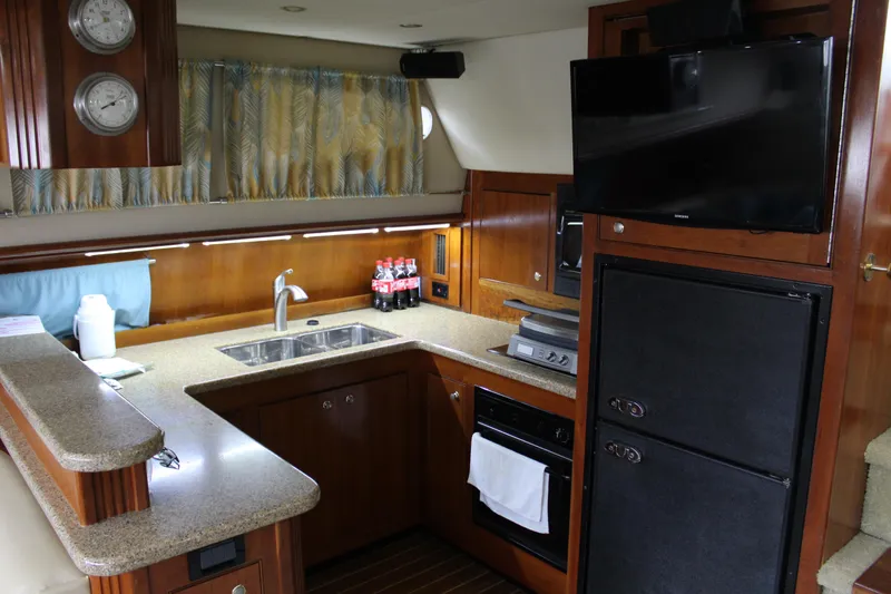 Slide: The Image of Luxurious kitchen in 2005 Cruisers 455 Express Motor Yacht with modern amenities. - 17