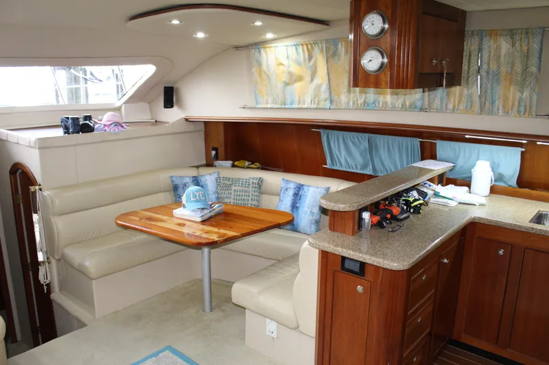 Slide: The Image of Luxurious 2005 Cruisers 455 Express Motor Yacht interior with elegant seating and kitchen area. - 18