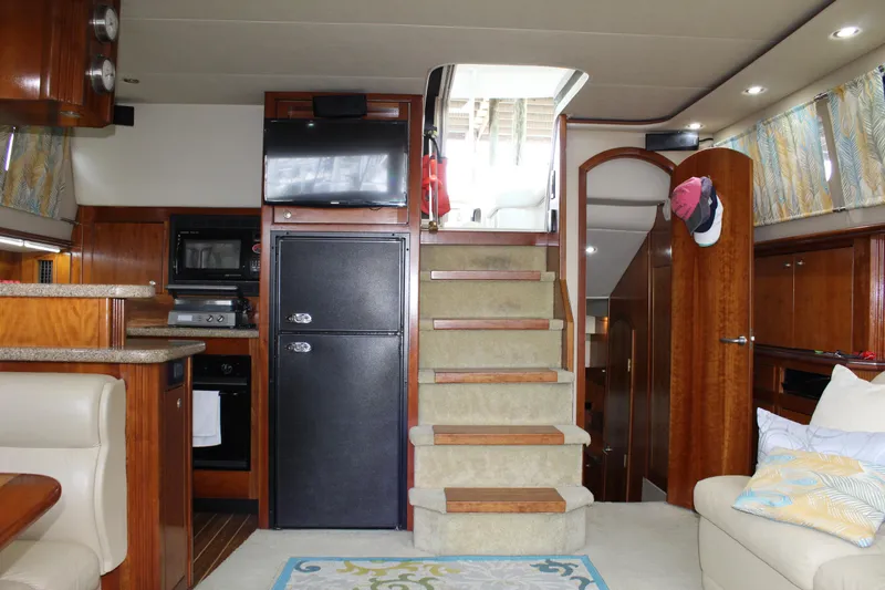 Slide: The Image of Interior of 2005 Cruisers 455 Express Motor Yacht with stairs, kitchen, and seating area. - 19