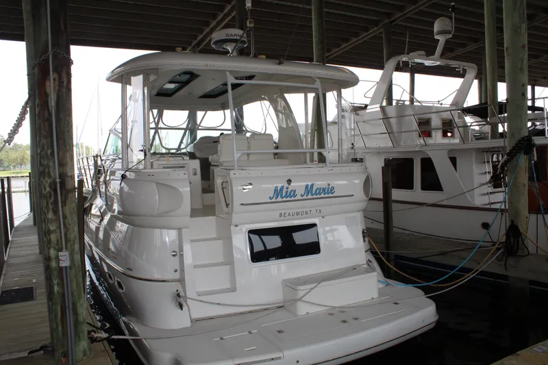 Slide: The Image of 2005 Cruisers 455 Express Motor Yacht docked in marina. - 2