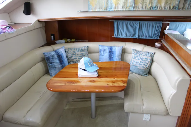 Slide: The Image of 2005 Cruisers 455 Express Motor Yacht interior with cozy seating and wooden table. - 20